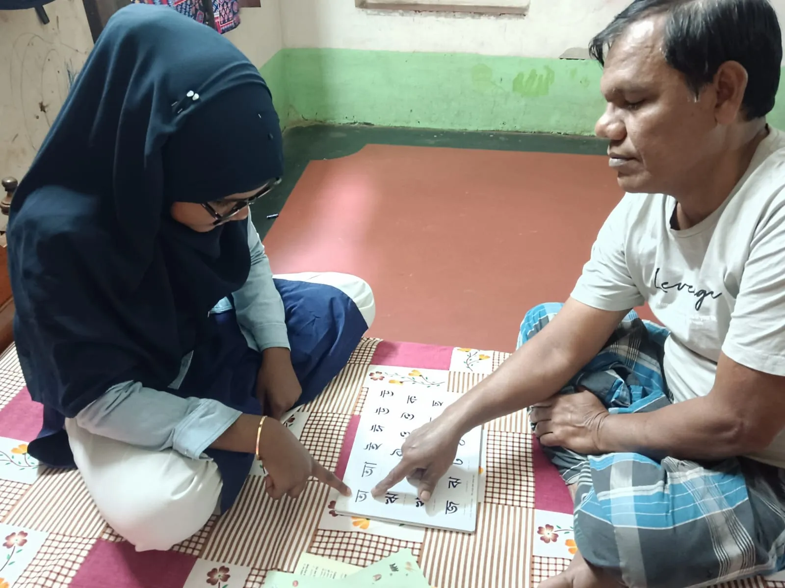 a young volunteer teaching an adult